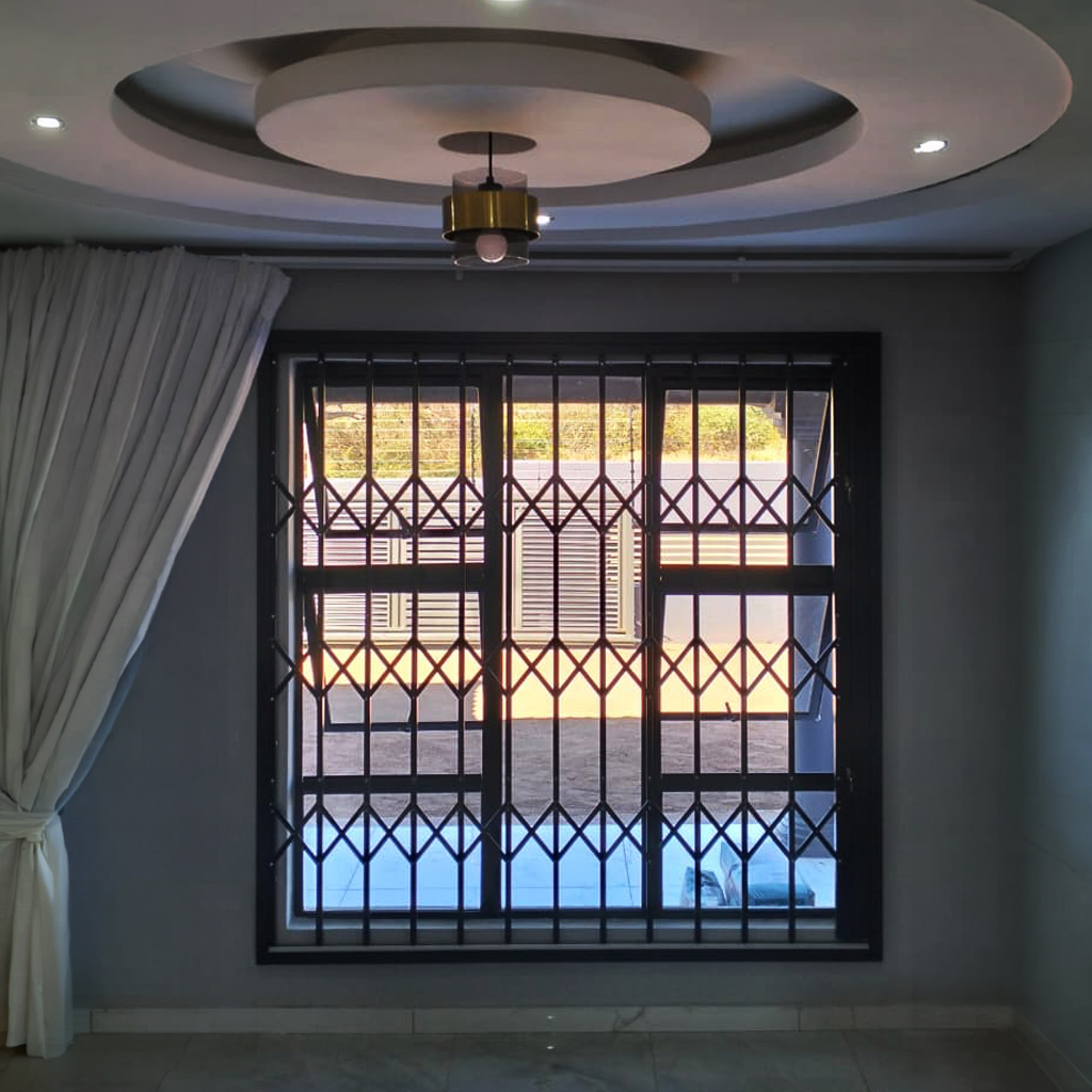 Custom powder-coated burglar bars fitted to a residential window