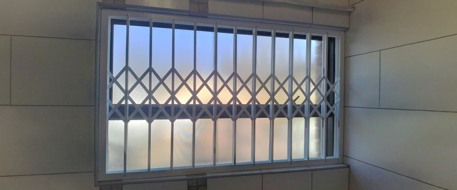Modern luxury house with integrated burglar bars at dusk